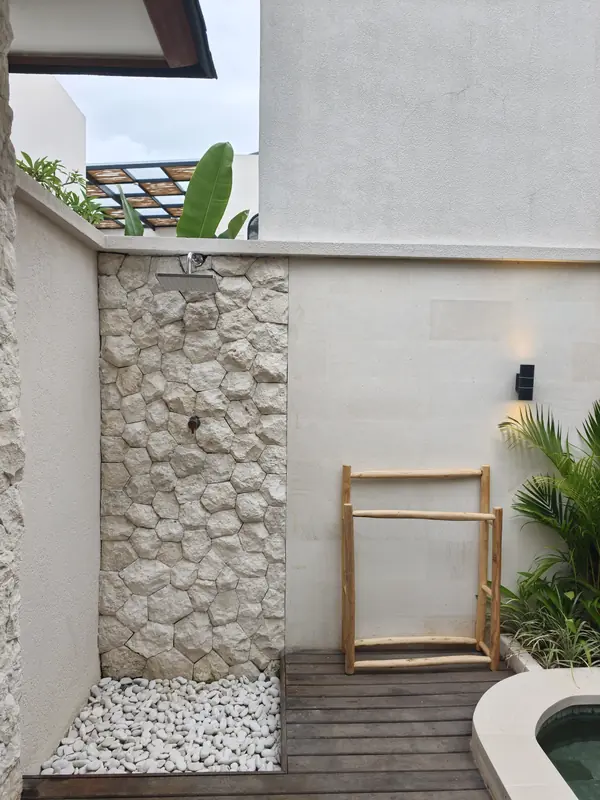 Outdoor shower with river stones
